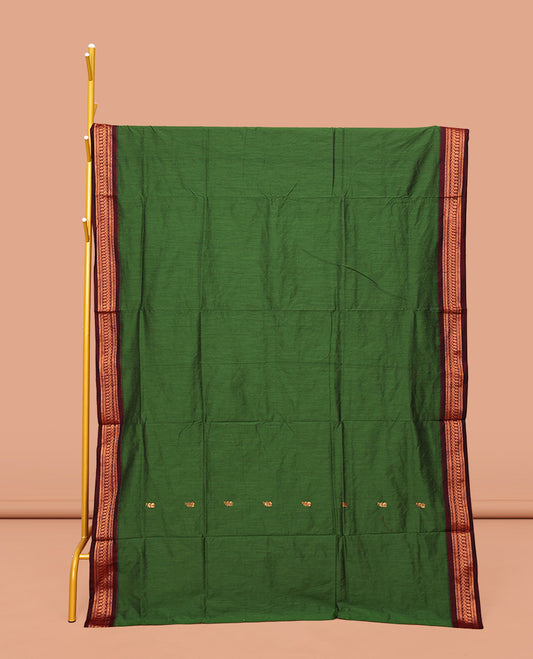 Green Kalyani Cotton Saree, Accentuated with Buttas All Over Its Body, Complemented by a Contrast Traditional Zari Design Temple Border, Pallu Features Traditional Zari Designs, and Paired with a Contrast Blouse