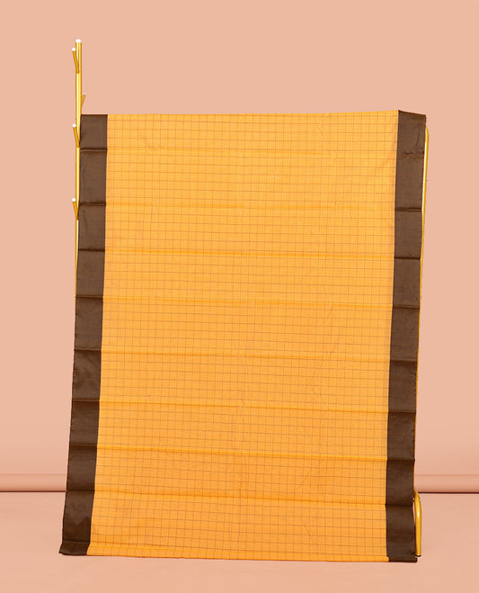 Yellow Semi-Silk Cotton Saree, Sparsely Threaded with Checks All Over Its Body, Complemented by a Contrast Border, Striped Pallu, and Paired with a Matching Blouse