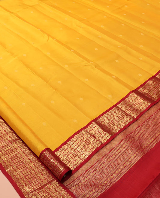 Yellow Vasundhara Lite Silk Mix Saree Features Zari Buttas, a Contrast Border of Thilakam Mokku, Muthu, Banaras, Rudraksham, and Neli Designs, Jaal Pallu, and a Contrast Blouse