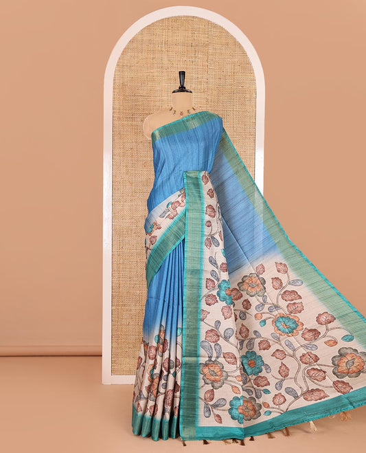 Blue plain fancy tussar saree, contrast floral printed border, floral vine printed pallu, and a contrast plain blouse