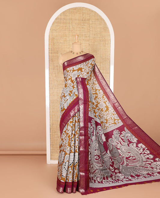Mustard kalamkari floral vine and peacock printed muslin cotton saree, contrast zari border, kalamkari peacock printed pallu, and a contrast coin buttas printed blouse