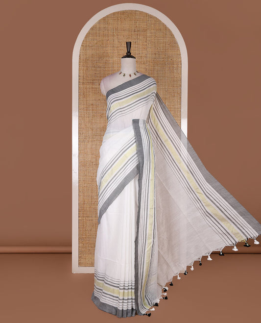 Cream-grey plain design mul mul cotton saree, contrast gold zari horizontally striped border, plain pallu, and plain blouse