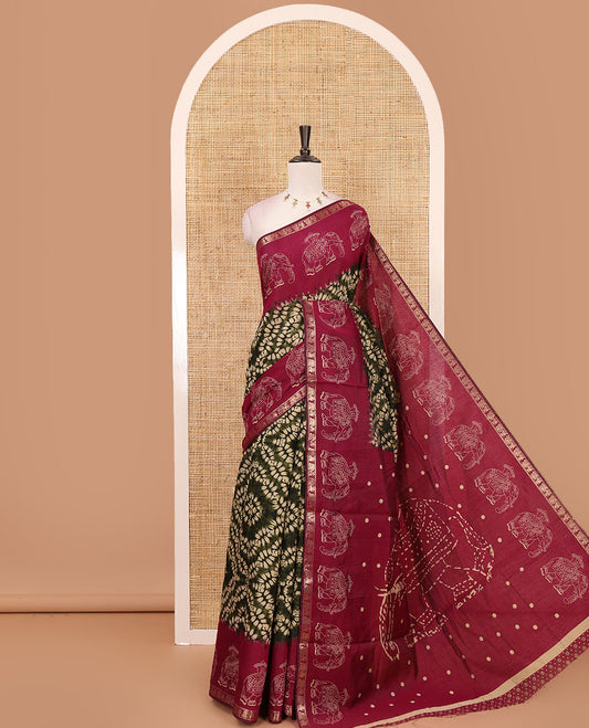 Olive green diamond patterns Shibori-style printed muslin cotton saree, contrast elephant motifs printed border, batik elephant motifs pallu & contrast flower buttas printed blouse