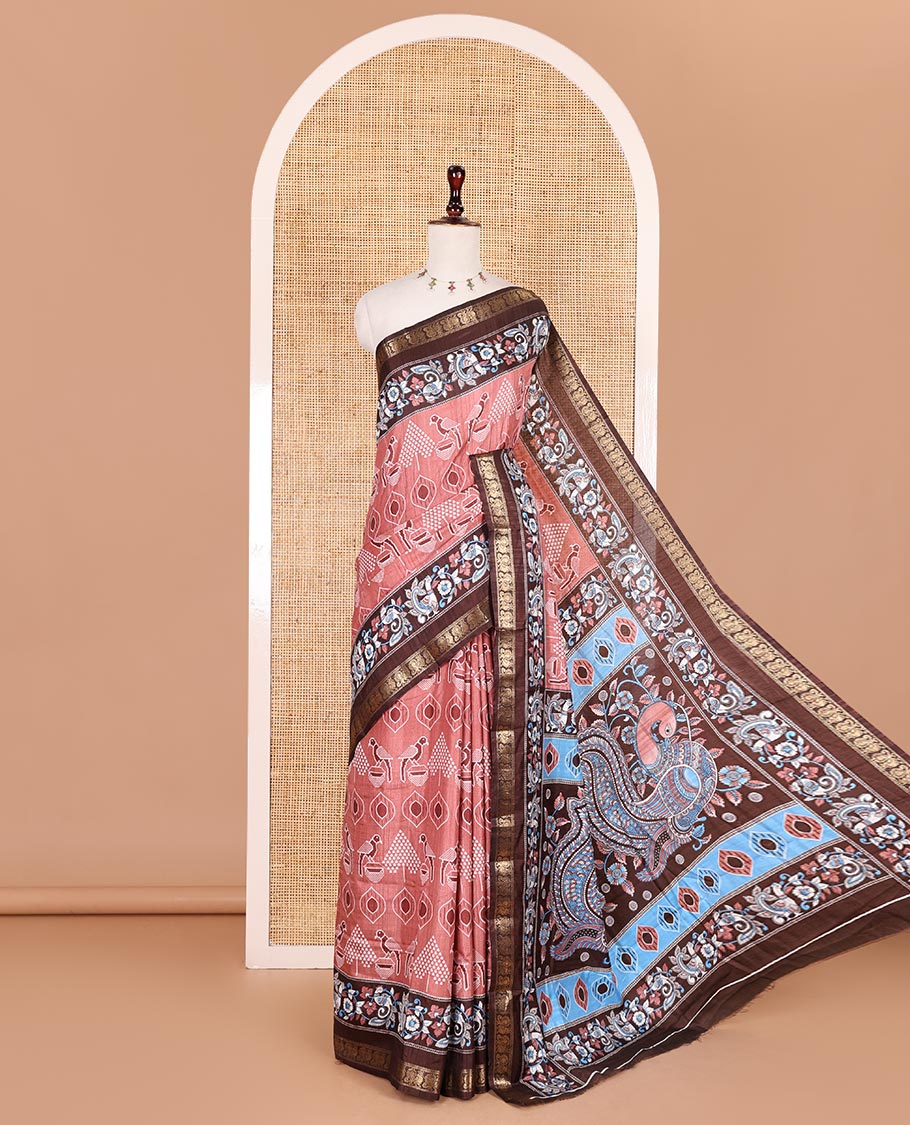 Peach pochampally ikkat parrot motifs printed dola silk saree, contrast border of kalamkari printed with zari work, kalamkari peacock printed pallu, and contrast zari design blouse