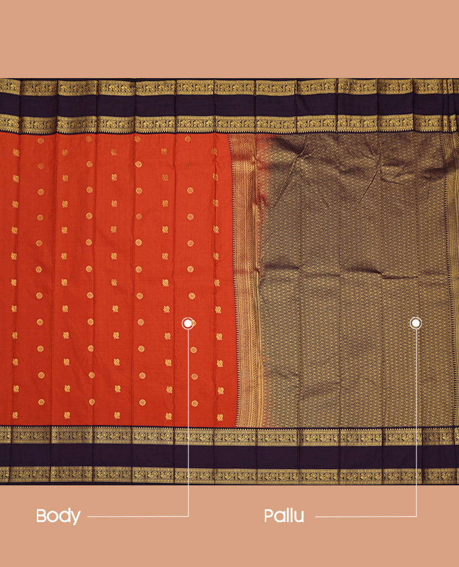 Rust Budget Silk Saree, Accentuated with Peacock and Chakram Buttas All Over Its Body, Complemented by a Contrast Traditional Zari Rettai Pettu Border of Peacock Designs, Pallu Steeped Thilakam Designs, and Paired with a Contrast Blouse
