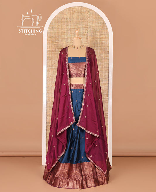 Peacock blue taffeta silk half-saree, flower zari buttas and contrast traditional zari bordered skirt, a matching blouse, and contrast embroidered satin georgette scallop dhavani