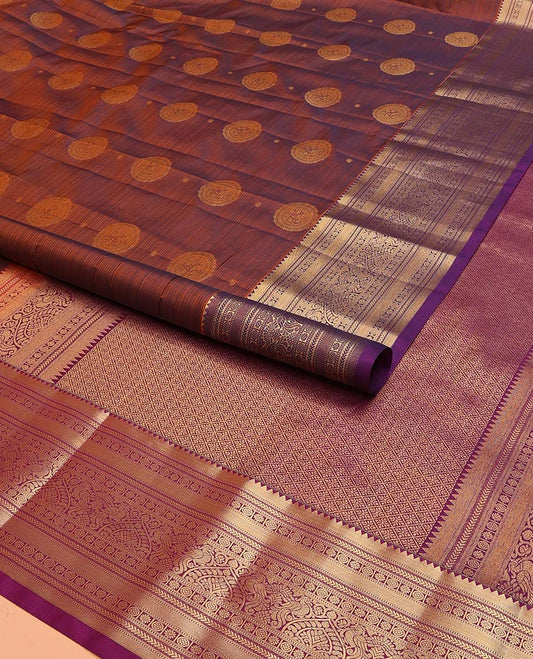 Brown Vasundhara Lite Silk Mix Saree Beautified with Chakram Zari Buttas, Complemented with a Contrast Border Featuring Rekku, Muthu, Kathir, Kamalam, and Mayil Designs, Pallu Elevated with Jaal Designs, and Paired with a Contrast Blouse