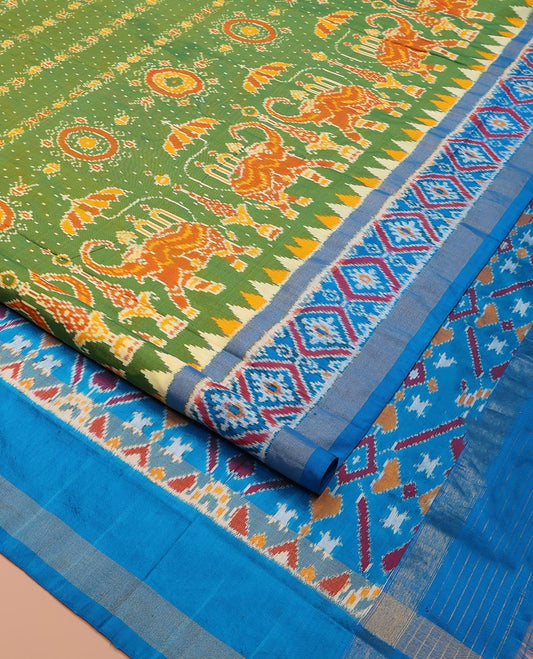 Green Ikkat Silk Saree, Enriched with Elephant Motifs Ikkat Weave All Over Its Body, Complemented by a Contrast Temple Border of Diamond Designs, Pallu of Ikkat Designs, and Paired with a Contrast Blouse