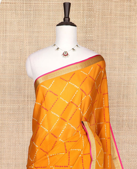 Orange bhandani style design crepe saree with contrast zari border & striped pallu