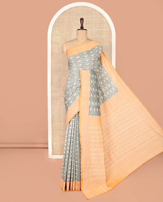 Grey Ikkat Cotton Saree, Accentuated with Ikkat-Style Ogee Patterns on Its Body, Complemented by Contrast Border, Pallu Steeped with Buttas, and Has No Blouse