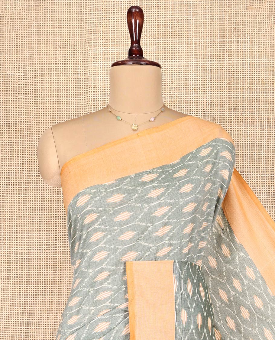 Grey Ikkat Cotton Saree, Accentuated with Ikkat-Style Ogee Patterns on Its Body, Complemented by Contrast Border, Pallu Steeped with Buttas, and Has No Blouse