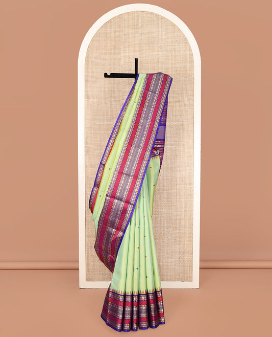 Green Kanchipuram Silk Saree, Beautifully Bedecked with Thread Buttas All Over Its Body, Complemented by a Contrast Border of Thazampoo Rekku, Muthu, Star Vanki, and Rudraksham Designs, Seppu Rekku Pallu, and Paired with a Contrast Blouse