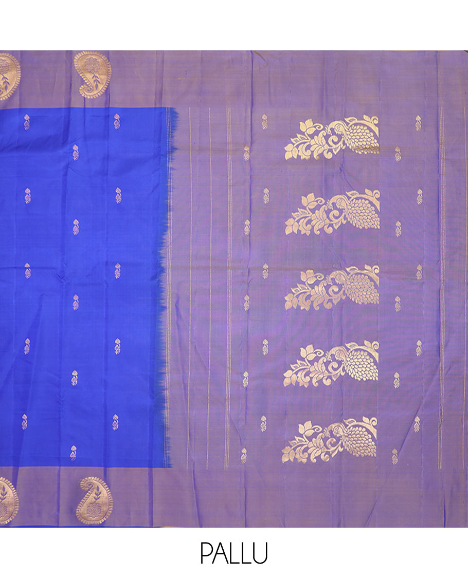 Blue Kanchipuram Silk Saree Featuring All-Over Zari Buttas, Highlighted by a Contrast Border with Manga Zari Buttas, and a Pallu Adorned with Mayil Motifs, Paired with a Subtle Contrast Plain Blouse