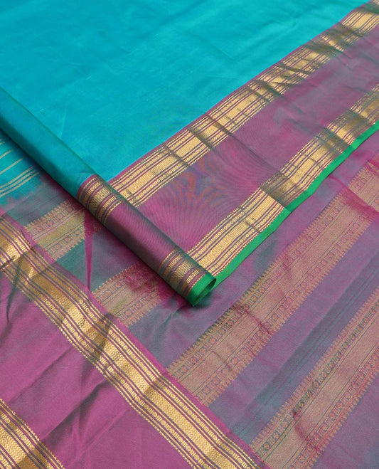 Blue plain Kanchipuram silk saree, contrast rettai pettu border of rekku, banaras, poun and vanki designs, and zari design pallu