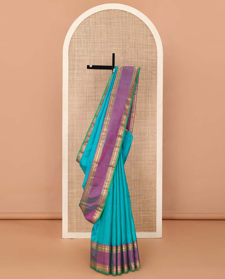 Blue plain Kanchipuram silk saree, contrast rettai pettu border of rekku, banaras, poun and vanki designs, and zari design pallu