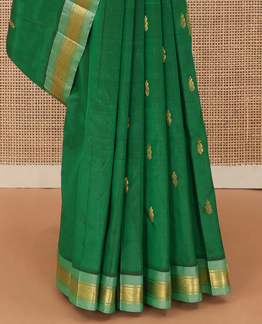 Green Kanchipuram Silk Saree, Beautified with Zari Buttas All Over Its Body, Complemented by Contrast One-Sided Border of Rekku, Banaras, and Mayil Kann Designs, Pallu of Zari Designs, and Comes Without a Blouse