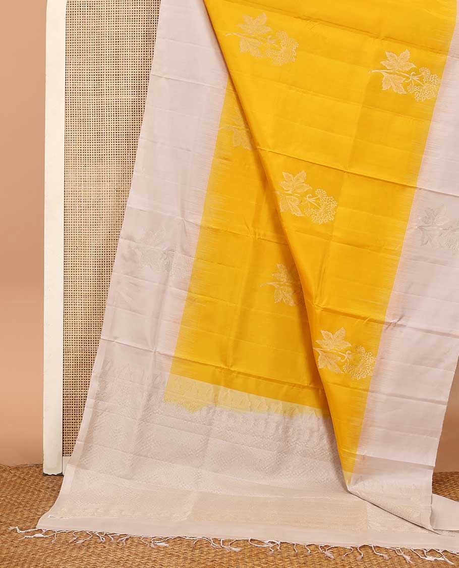 Yellow floral buttas soft silk saree, contrast border of floral buttas, and intricate pallu
