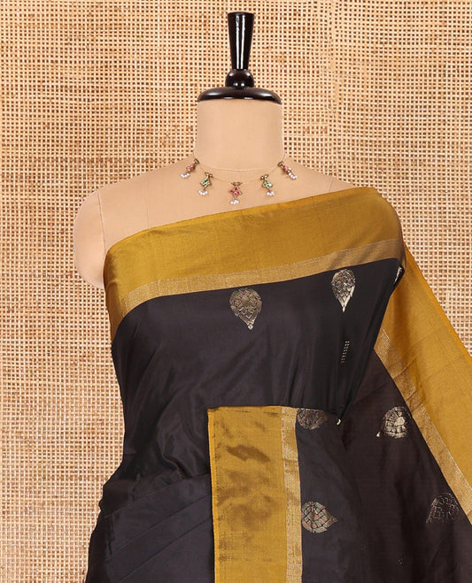 Black dobby and thilakam buttas semi-soft silk saree, contrast zari striped border, zari buttas pallu, and a matching blouse