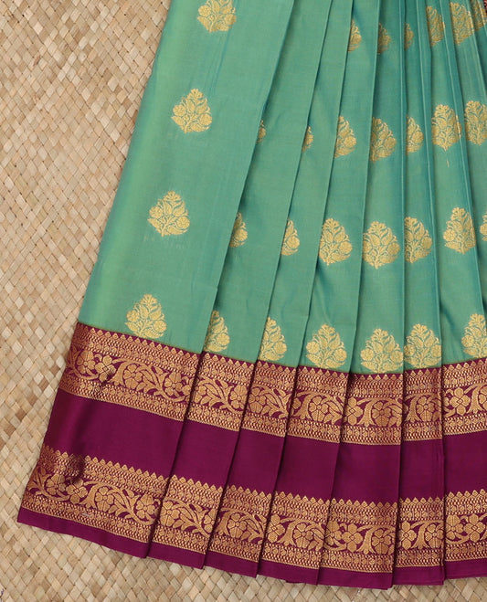 Green Budget Silk Saree Beautified with Zari Buttas, Complemented with a Contrast Traditional Zari Design Rettai Pettu Border, Grand Ogee Patterned Pallu, and Paired with a Contrast Blouse