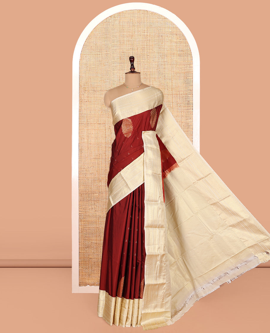 Rust Budget Silk Saree, Gracefully Embellished with Zari Buttas on Its Body, Complemented by a Contrast Traditional Zari Design Border, Subtly Sparkled Pallu, and Paired with a Contrast Blouse