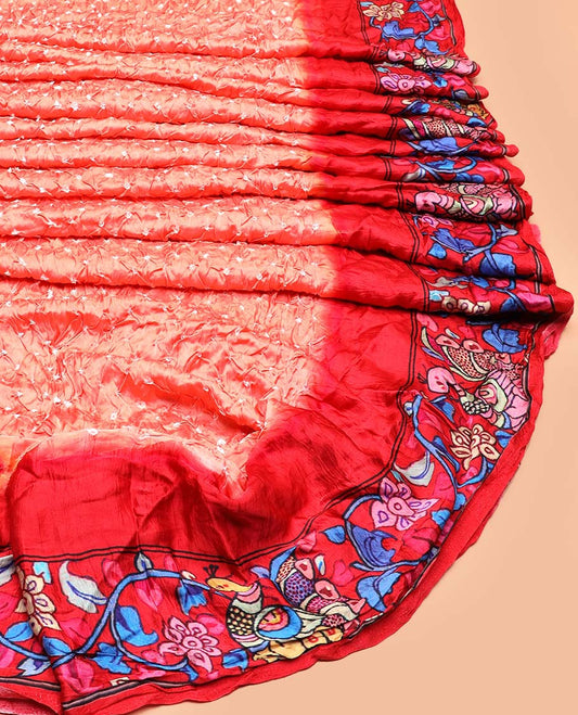 Peach bandhani dotted bandhani silk saree, contrast kalamkari floral vine and peacocks printed border of peacock printed pallu