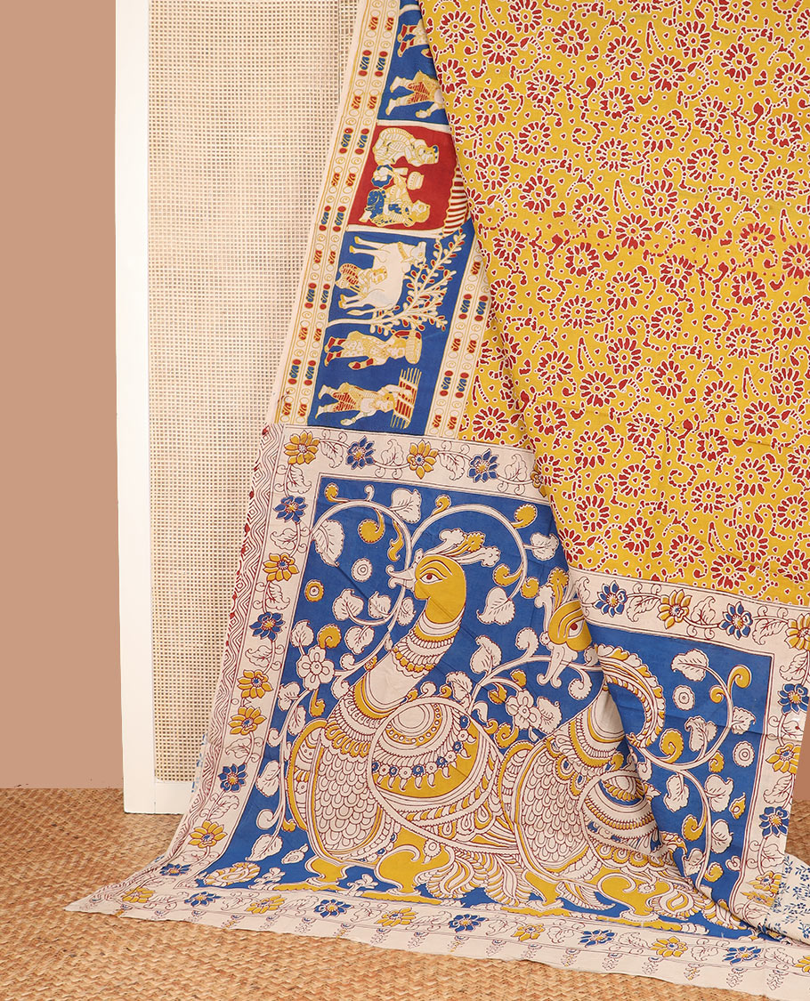 Yellow batik floral machine-printed cotton saree, contrast printed border, and pallu of kalamkari peacock print