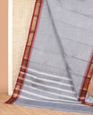 Grey striped Chettinad cotton saree, contrast traditional zari temple border, and striped pallu