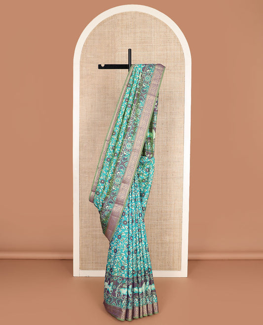 Blue floral vine patola silk saree, contrast traditional zari border and pallu of Pichwai cow and peacock motifs
