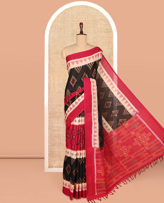 Black Ikkat Cotton Saree, Ornamented with Ikkat-style Buttas All Over Its Body, Complemented by a Contrast Temple Border, Pallu of Geometric Patterns, and Paired with a Contrast Blouse