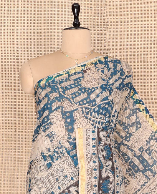 Blue Machine-Printed Kalamkari Cotton Saree Features Human Motifs, a Piping Border, Pallu of Peacocks, and a Matching Blouse