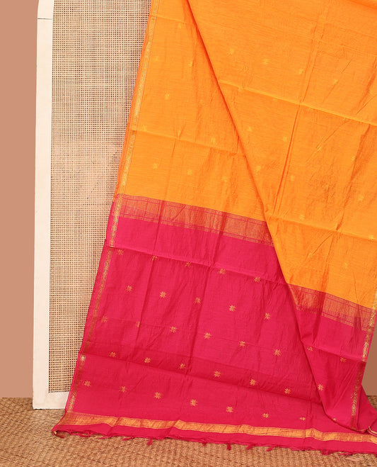 Orange Maheshwari Cotton Saree, Detailed with Flower Buttas All Over Its Body, Subtly Woven Piping Border, Captivating Contrast Pallu Steeped with Buttas, and Paired with a Contrast Blouse