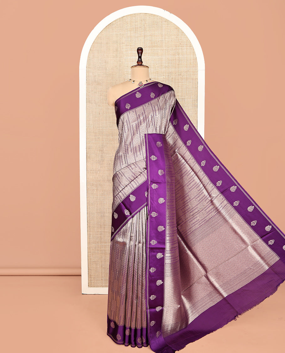 Purple Russian Dola Silk Saree, Meticulously Crafted with Zari Zig-Zag Jacquard on Its Body, Highlighted by Zari Buttas Woven Satin Border, Intricately Designed Pallu, and Paired with a Matching Blouse