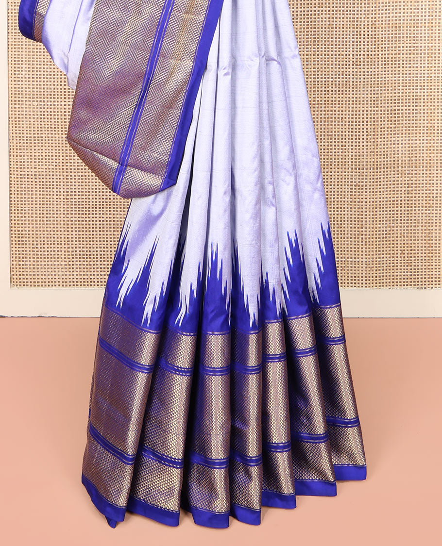 Grey Plain Ikkat Silk Saree, Complemented by a Contrast Temple Border of Diamond Designs, Pallu Features Ikkat Fauna Designs, and Paired with a Contrast Blouse