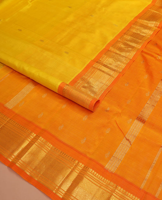 Yellow zari buttas Kanchipuram silk saree, contrast one-sided border of paneer sombu, banaras, muthu, and jaal designs, and zari design pallu