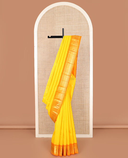 Yellow zari buttas Kanchipuram silk saree, contrast one-sided border of paneer sombu, banaras, muthu, and jaal designs, and zari design pallu
