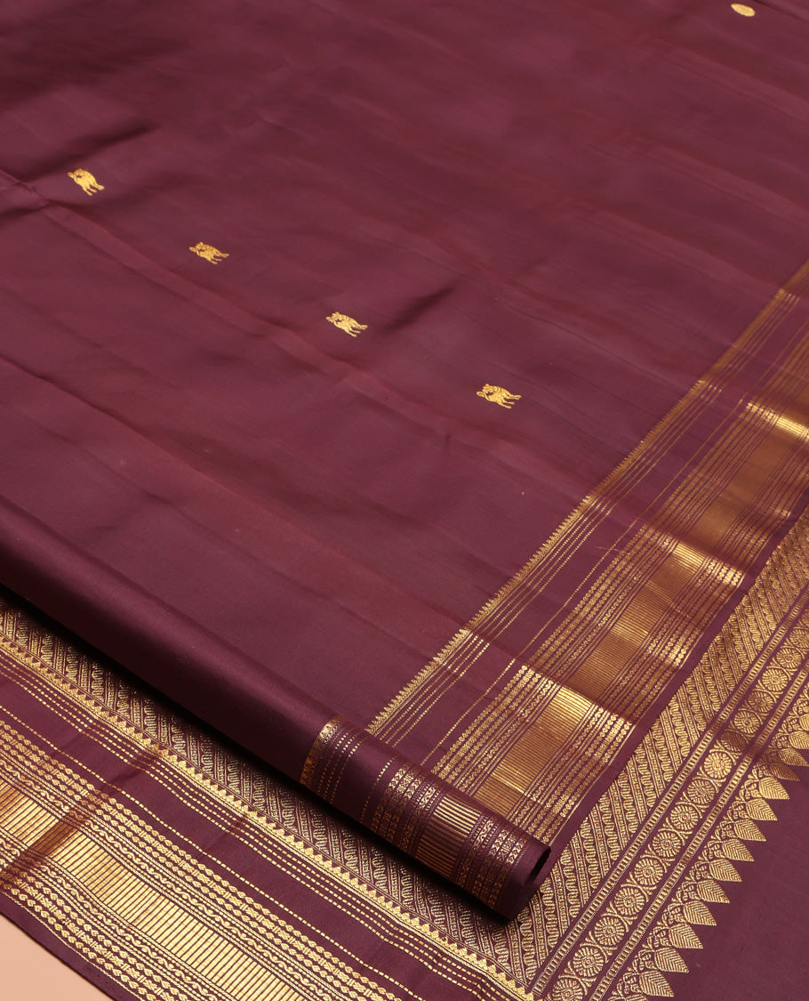 Brown Kanchipuram Silk Saree, Subtly Enriched with Yaali Buttas All Over Its Body, Highlighted by Zari Border of Thilakam, Muthu, Cross Kamalam, and Neli Designs, Grand Pallu, and Paired with a Matching Blouse