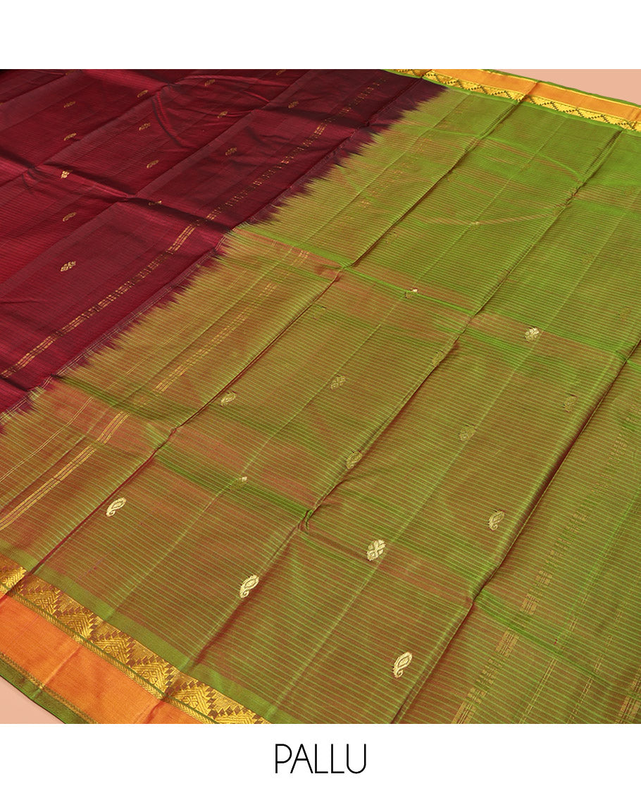 Maroon Kanchipuram Silk Saree, Sparsely Woven with Vazhaipoo Stripes and Buttas on Its Body, Complemented by Contrast Rettai Pettu Border of Thazampoo Rekku, and Kathir Designs, Zari-Striped Pallu, and Paired with a Contrast Blouse