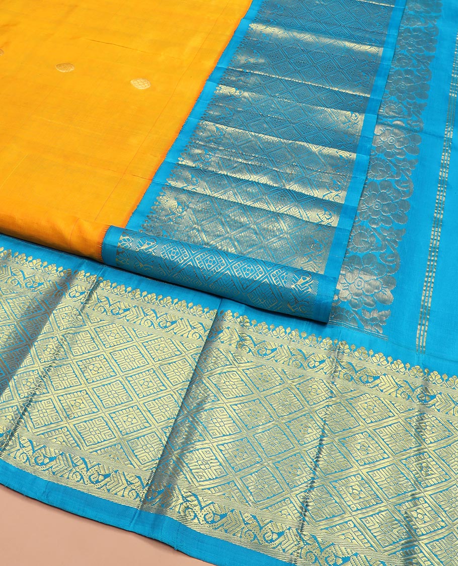 Yellow Kanchipuram Silk Saree Meticulously  Woven with Zari Buttas All Over Its Body, Complemented by a Contrast One-Sided Korvai Border of Jaal Designs, Richly Woven Pallu of Intricate Motifs in Zari, and Comes Without a Blouse