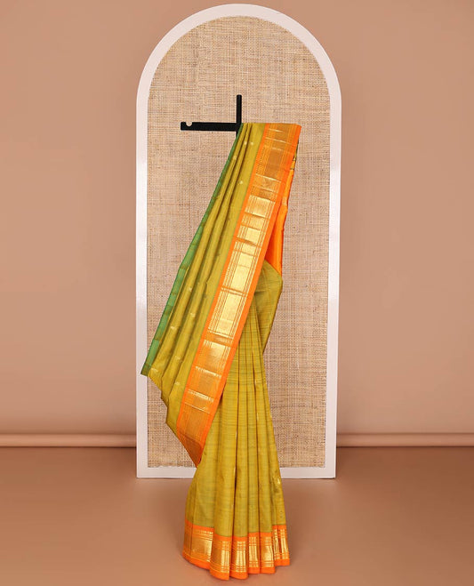 Green kancheepuram silk saree with zari buttas, contrast one-sided border of paneer sombu, banaras, muthu & mayil kann & zari design pallu