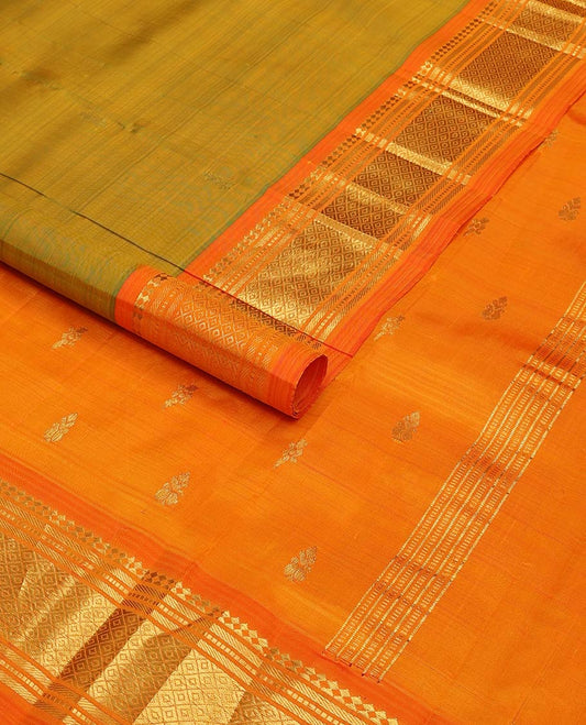Green kancheepuram silk saree with zari buttas, contrast one-sided border of paneer sombu, banaras, muthu & mayil kann & zari design pallu