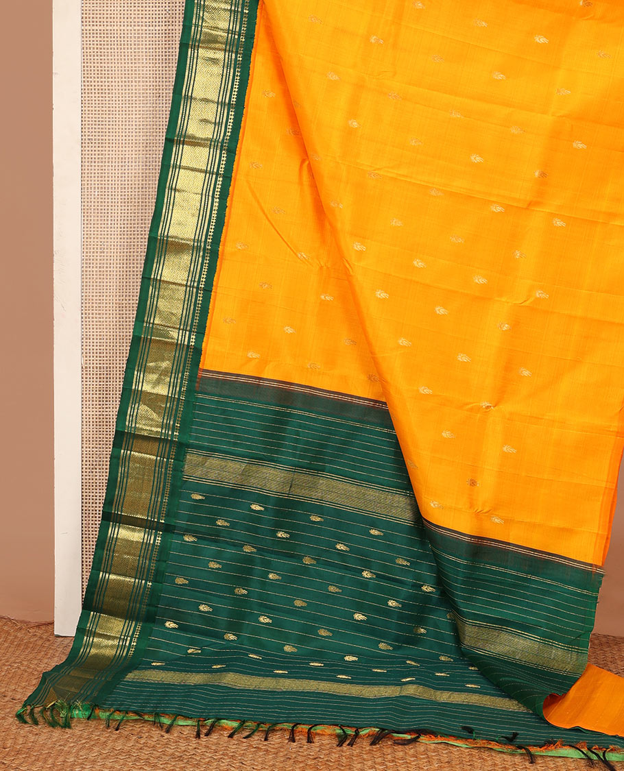 Yellow zari buttas Kanchipuram silk saree, contrast one-sided korvai border of panner, sombu, banaras, muthu, and mayil kann and zari design pallu