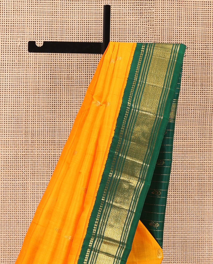 Yellow zari buttas Kanchipuram silk saree, contrast one-sided korvai border of panner, sombu, banaras, muthu, and mayil kann and zari design pallu