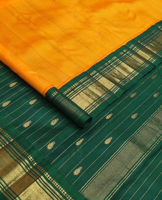 Yellow zari buttas Kanchipuram silk saree, contrast one-sided korvai border of panner, sombu, banaras, muthu, and mayil kann and zari design pallu