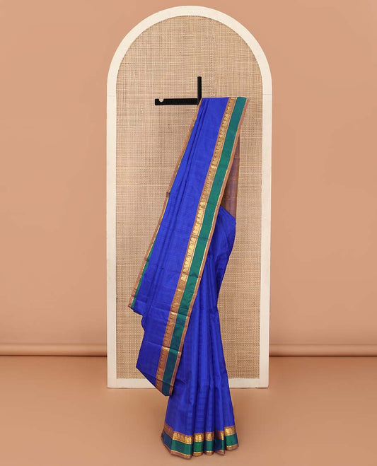 Royal blue checked Kanchipuram silk saree, contrast border of manga, neli, and diamond designs, and striped pallu