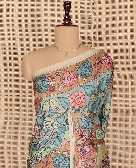 Blue Semi-Tussar Saree Gracefully Embellished with Kalamkari-Style Floral Vine Print, Captivating Contrast Floral Printed Border, Pallu Depicting Ancient Figurines Print, and Paired with a Contrast Printed Blouse