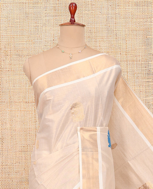 Cream Kerala Cotton Saree, Bedecked with Thread and Zari Buttas All Over Its Body, a Zari Bavanji Border, Pallu of Intricate Designs, and Paired with a Matching Blouse