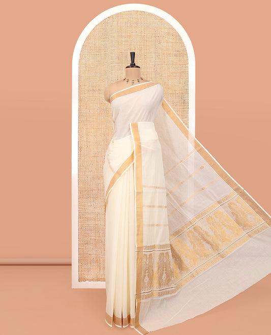 Cream Kerala Cotton Saree, Enriched with Zari Stripes All Over Its Body, a Subtle Bavanji Border, Pallu Features Peacock Designs, and Paired with a Matching Blouse