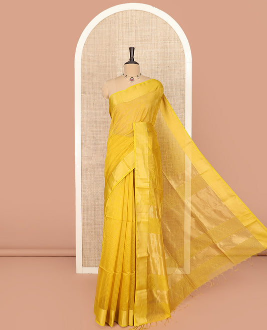 Yellow Maheshwari Cotton Saree Sparsely Sparkled with Zari Checks, Subtly Woven with a Traditional Zari Design Border, Pallu Gleamed Up with Zari Stripes, and Paired with a Matching Blouse