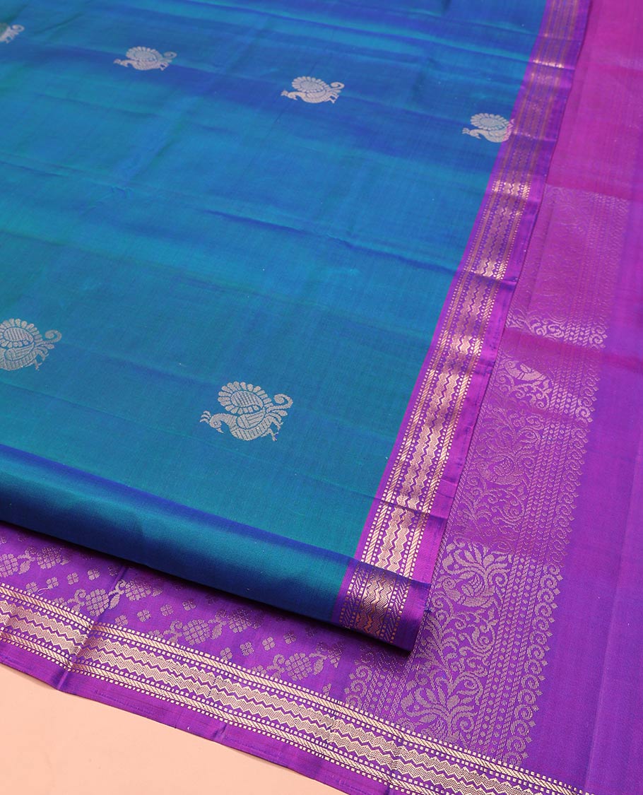 Blue Mayuri Soft Silk Saree, Decorated with Mayil Buttas All Over Its Body, Complemented by Contrast Border of Muthu, Banaras, and Chevron Designs, Pallu Elevated with Floral Creeper Designs, and Paired with Contrast Blouse