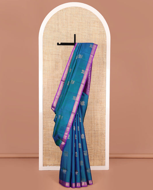 Blue Mayuri Soft Silk Saree, Decorated with Mayil Buttas All Over Its Body, Complemented by Contrast Border of Muthu, Banaras, and Chevron Designs, Pallu Elevated with Floral Creeper Designs, and Paired with Contrast Blouse
